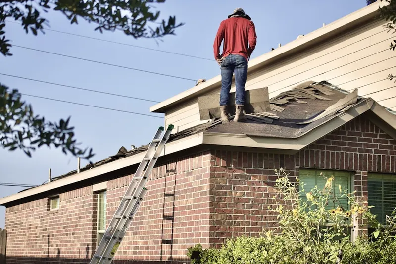 Professional roofer working on a residential roof in Efland